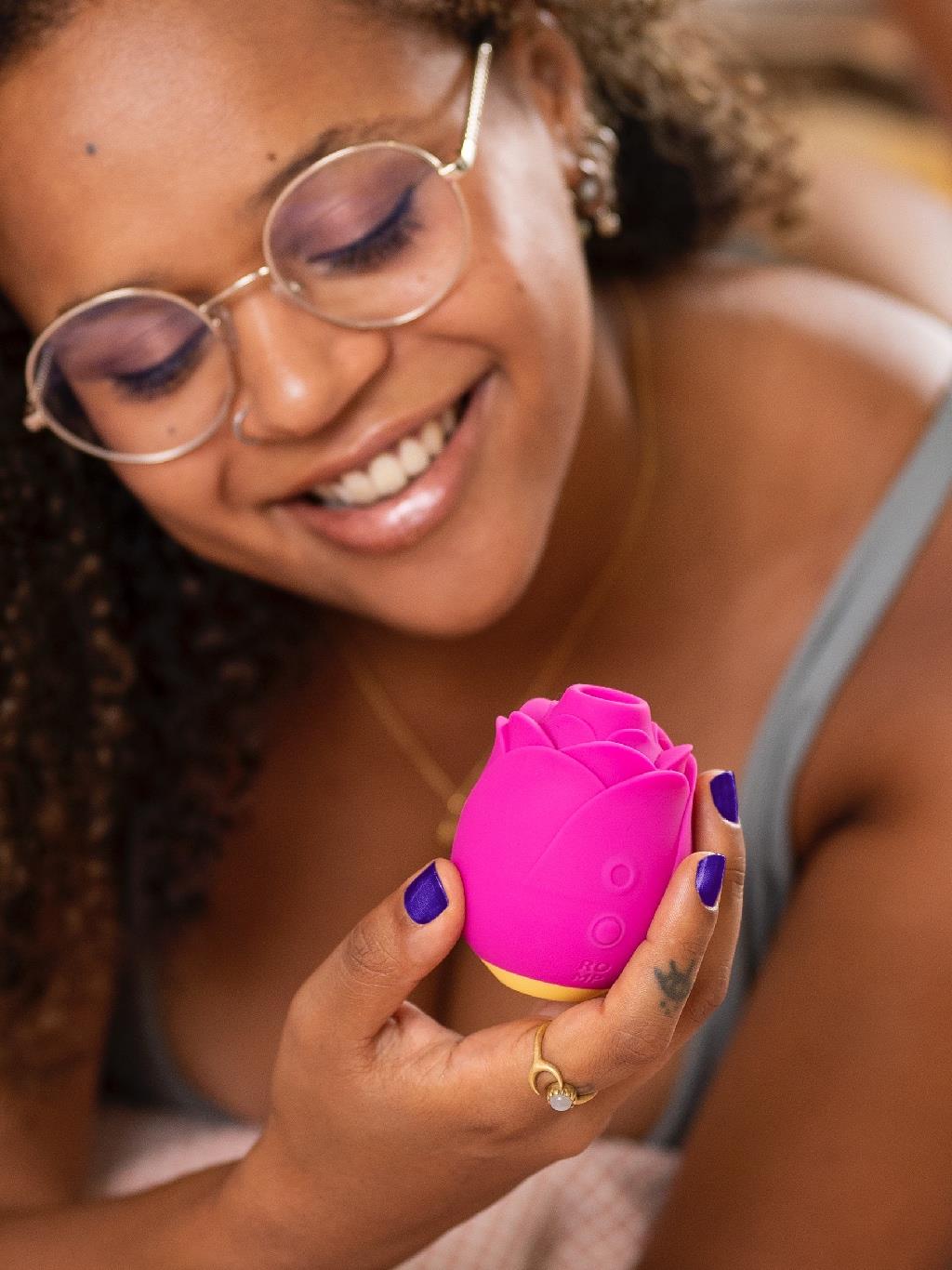 Unboxed Romp Rose Vibrator featuring compact, floral design and USB charging cable
