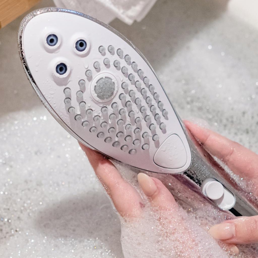 Close-up of Womanizer Wave waterproof showerhead designed for pleasure and relaxation