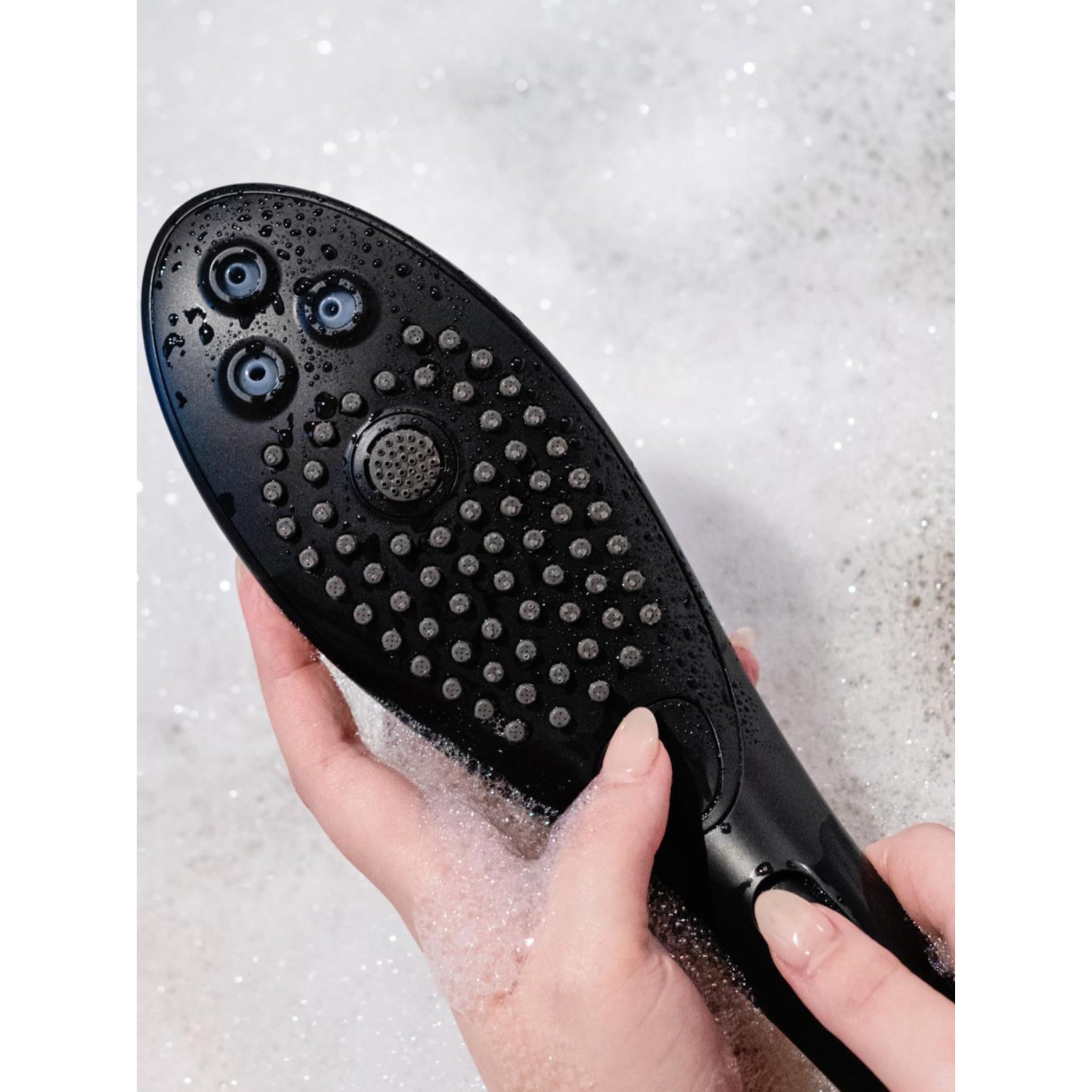 Close-up of Womanizer Wave waterproof showerhead designed for pleasure and relaxation