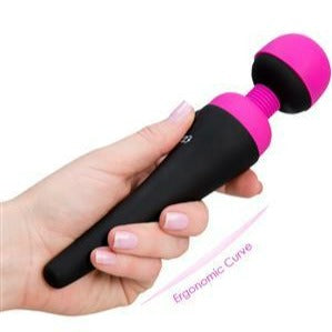 Compact pink wand massager held in hand to show cordless size and ergonomic grip