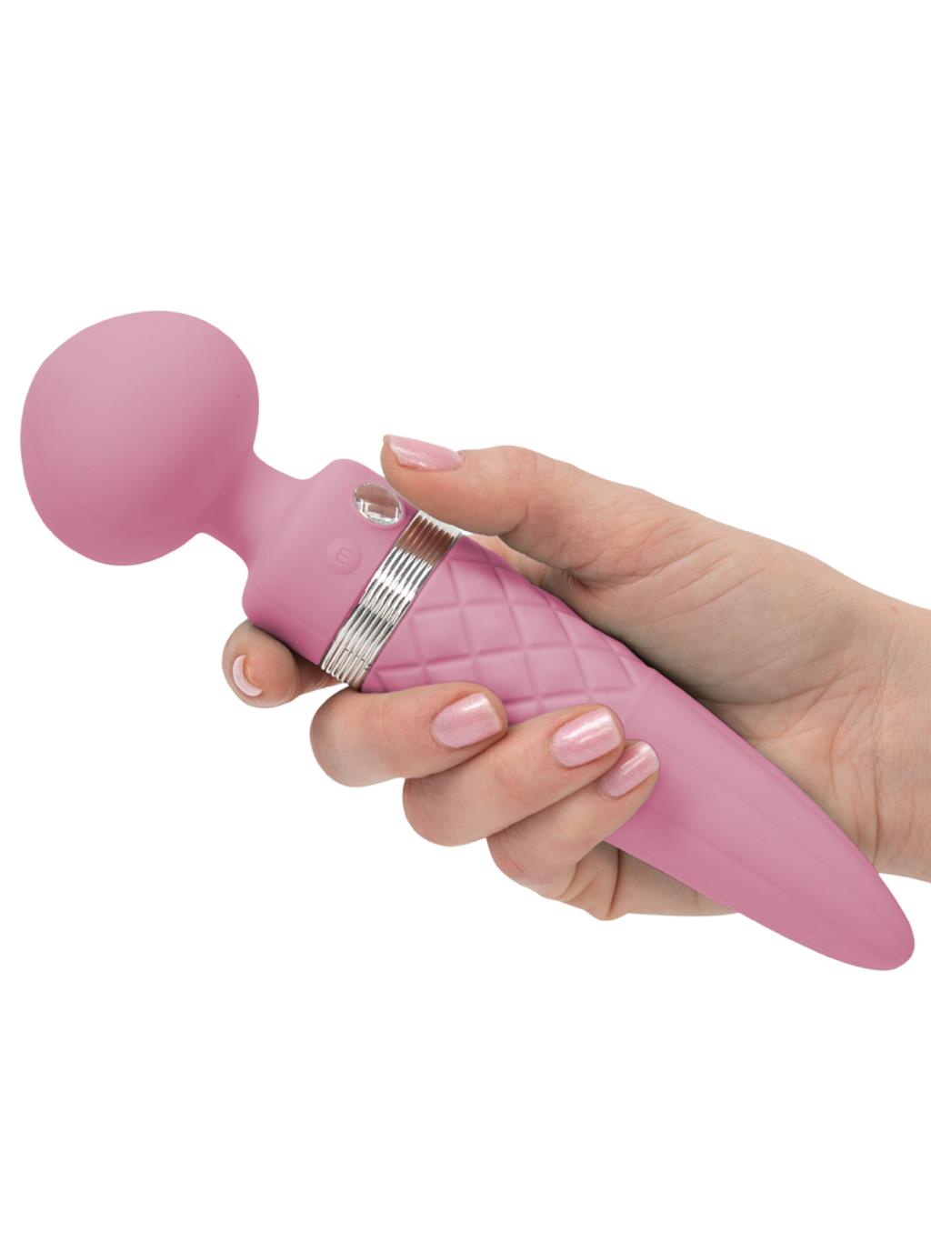 Hand holding the Swan Pillow Talk Sultry, showing compact size and premium finish