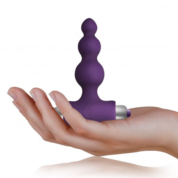 Close-up of purple vibrating anal beads with smooth silicone finish and T-bar base