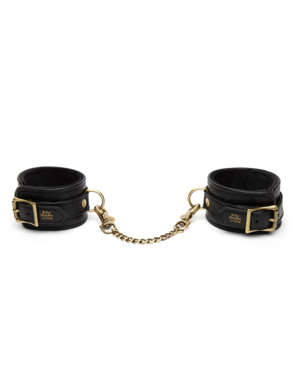 Fifty Shades Bound to You Ankle Cuffs with gold hardware shown flat with packaging, highlighting luxurious faux leather design.
