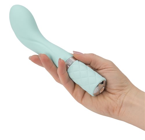 Teal G-spot vibrator held in hand showing curved shape and textured handle