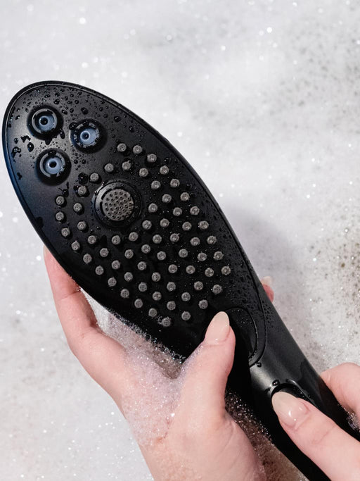 Close-up of Womanizer Wave waterproof showerhead designed for pleasure and relaxation