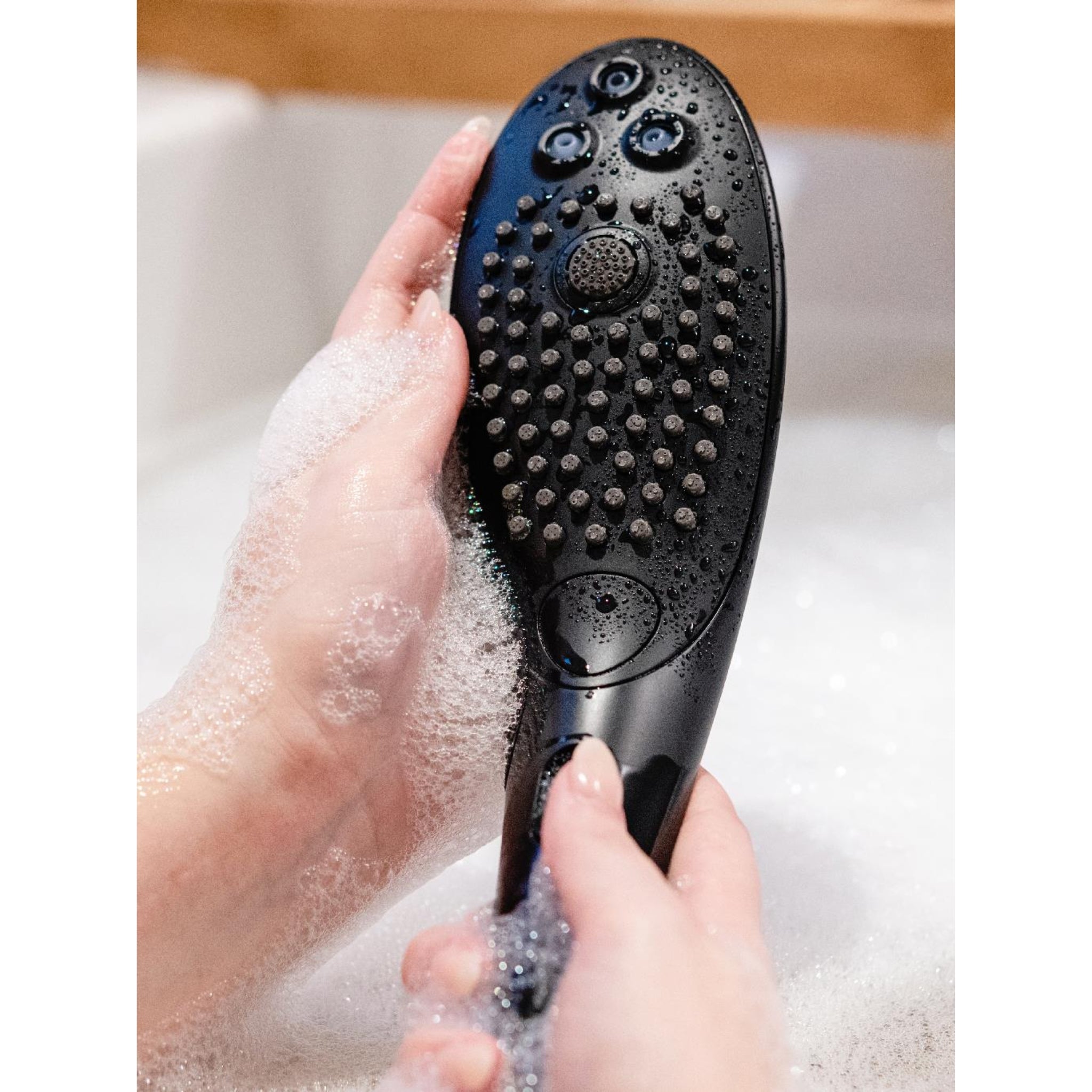 Close-up of Womanizer Wave waterproof showerhead designed for pleasure and relaxation
