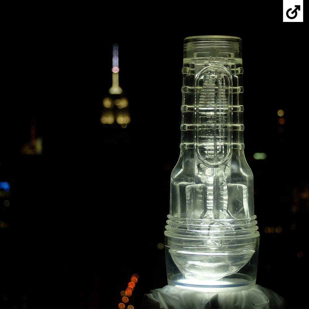 Fleshlight placed on moody surface, showcasing sleek design and realistic entry