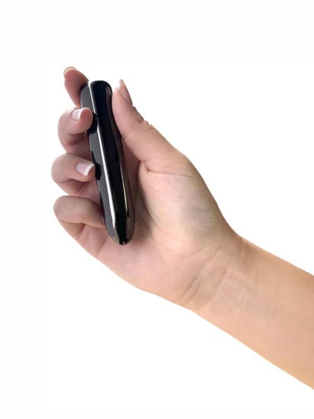 Swan Compact Bullet Point Vibrator held in hand, showing its petite size and curved tip for focused clitoral stimulation.
