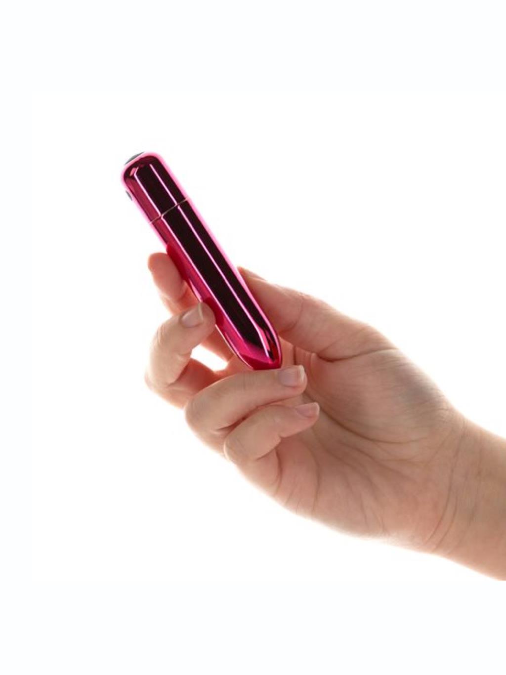 Swan Compact Bullet Point Vibrator held in hand, showing its petite size and curved tip for focused clitoral stimulation.