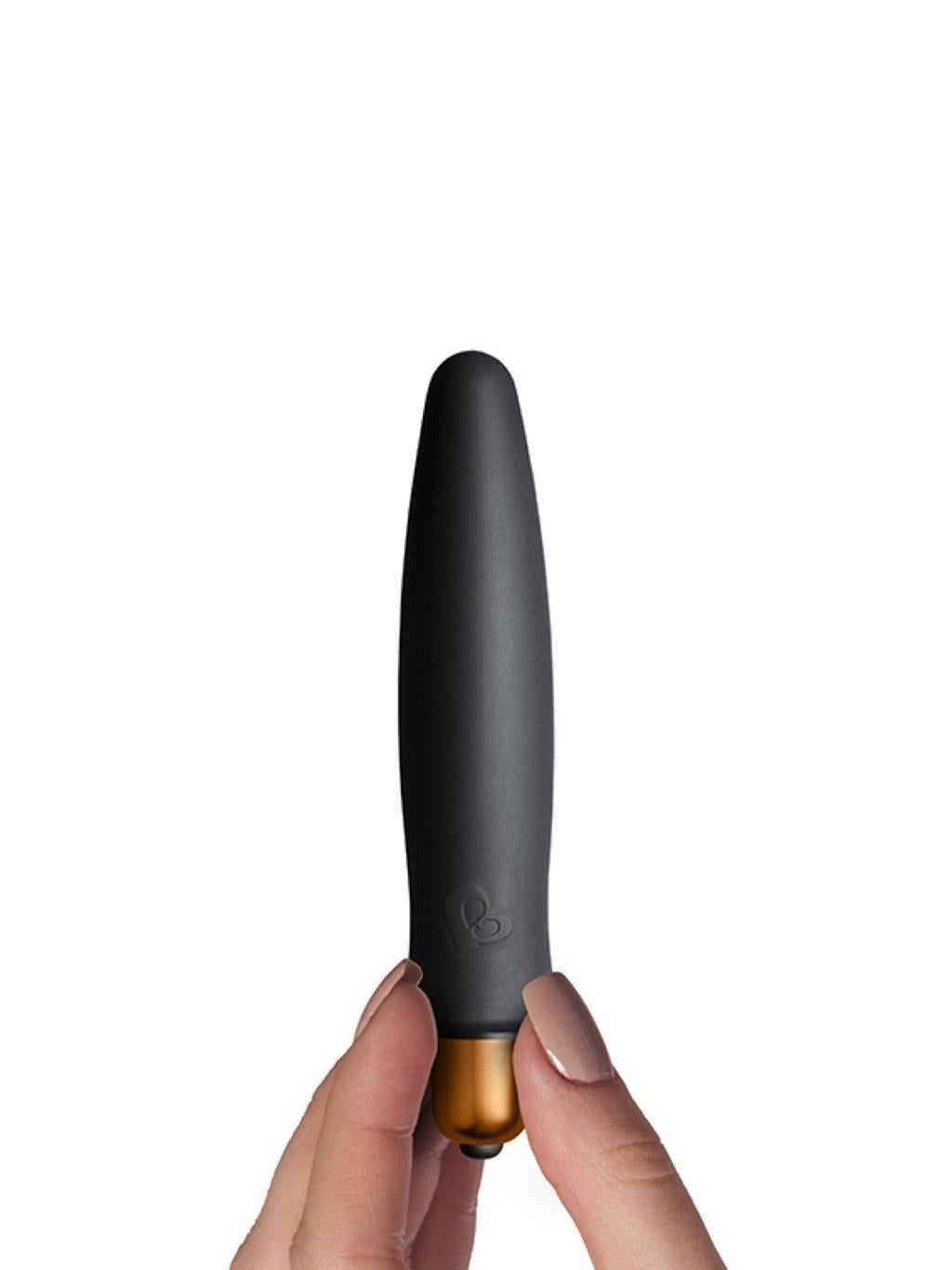 Mini black vibrator with soft silicone tips shown in palm for scale
